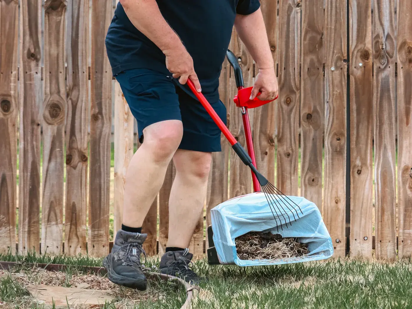 Rhino Scoop technician working in a fenced yard